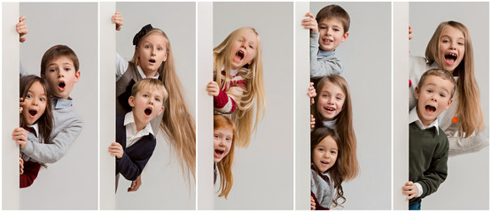 Banner with a surprised children peeking at the edge with copyspace. The portrait of cute little...