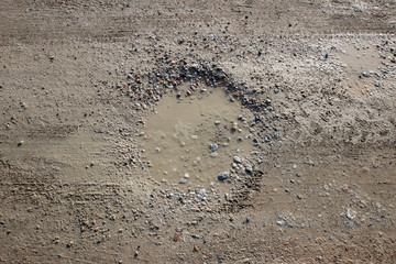 Muddy dirt road puddle circular shape tracks
