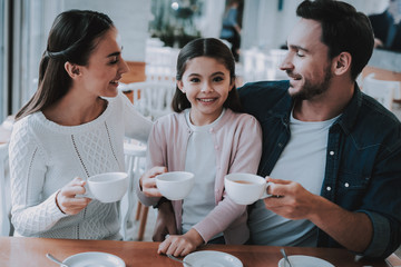 Young Family is Resting in Cafe