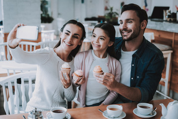 Young Family is Doing Selfie in Cafe