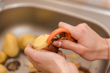 Woman peels potatoes. Cooking food. Homemade food. natural food.