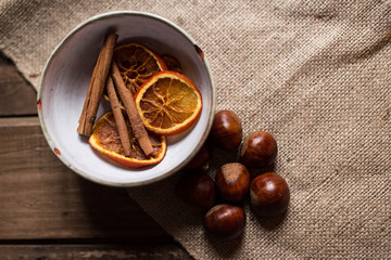 Chestnuts, cinnamon, and orange in a bowl 