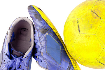 old  football shoes damaged and old  dirty yellow futsal ball on white background football  object isolated