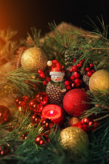 spruce branches and Christmas decor. decor toy Christmas still life.  dark tone, soft focus, toning