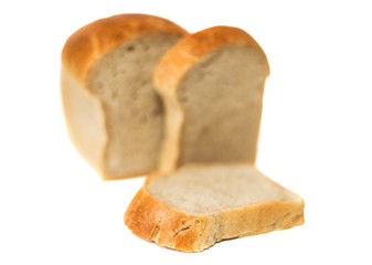 loaf of white bread with chopped pieces of selective focus isolate on a white background. white bread loaf isolated. Loaf of bread isolated on white background