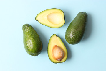  Avocado fruit on a colored background top view.