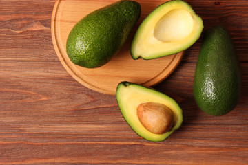  Avocado fruit on wooden table top view.