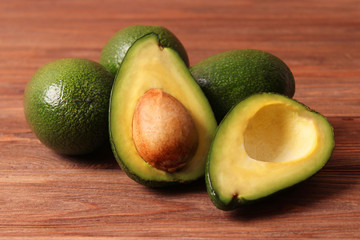  Avocado fruit on wooden table top view.