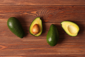  Avocado fruit on wooden table top view.