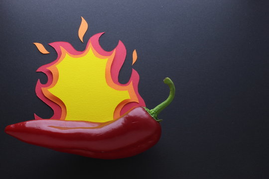 Red Chilli Pepper With A Paper Cut Art Fire Composition On Black Craft Paper Background