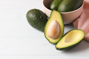  Avocado fruit on wooden table top view.