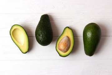  Avocado fruit on wooden table top view.