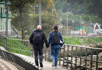 Couple Walks Along Boardwalk