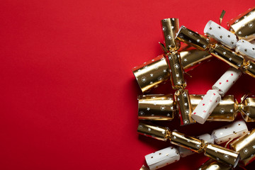 Festive Christmas crackers on a bright red background