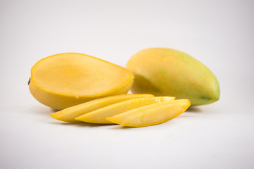 Yellow mango and mango slices isolated white background
