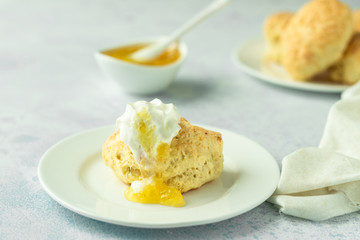 Traditional English scones with lemon jam and whipped cream. Copy space for text.