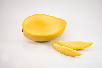 Yellow mango and mango slices isolated white background