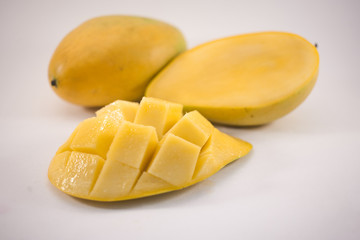 Yellow mango and mango slice with cubes isolated white background