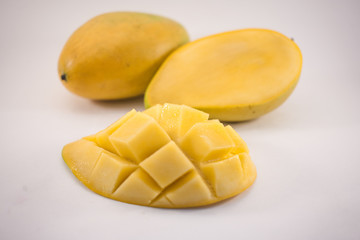 Yellow mango and mango slice with cubes isolated white background