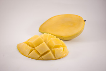 Yellow mango and mango slice with cubes isolated white background