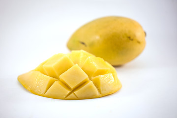 Yellow mango and mango slice with cubes isolated white background