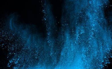 abstract blue powder splatted background,Freeze motion of color powder exploding/throwing color powder,color glitter texture on black background