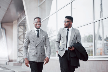 Business communication. Two cheerful business men talking to each other and discussing a project