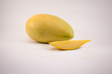 Yellow mango and mango slices isolated white background