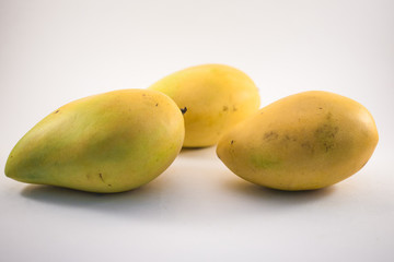 Three vietnamess mangoes on white background