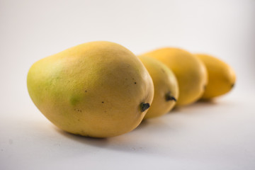 Four vietnamess mangoes on white background