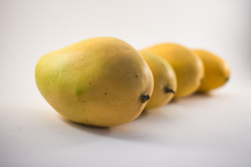 Four vietnamess mangoes on white background