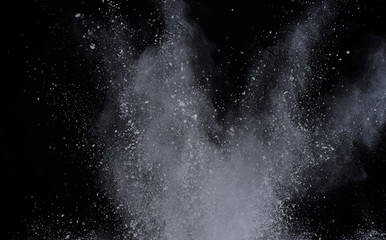 White powder explosion on black background. Colored cloud. Colorful dust explode. Paint Holi.