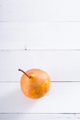 one pear on white wooden table background