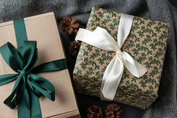 two gift boxes with bows on a dark background