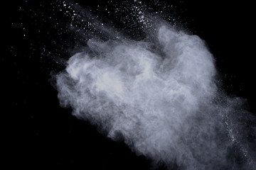 White powder explosion on black background. Dust splatted isolated. Paint Holi.