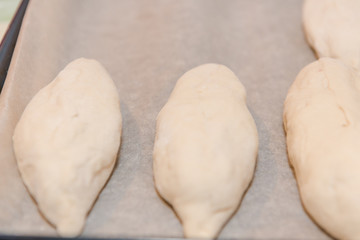 Pies on lie on a stand. Baking pies at home. Making potato pies. Natural products.