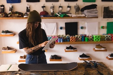 Woman using digital tablet in workshop