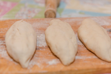 Pies on lie on a stand. Baking pies at home. Making potato pies. Natural products.