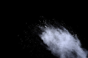 White powder explosion on black background. Dust splatted isolated. Paint Holi.
