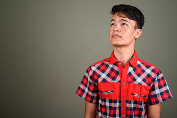 Fototapeta premium Young handsome Indian man against colored background