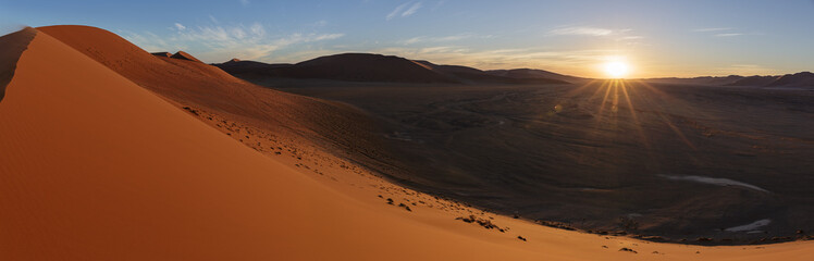 Fototapeta na wymiar A panorama view at sunset from dune 45 at Sossusvlei in Namibia
