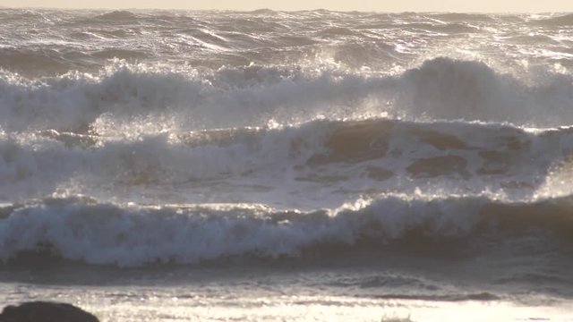 Big waves in a sunset lighting during a windy scirocco day on the Tyrrhenian coast of south Italy