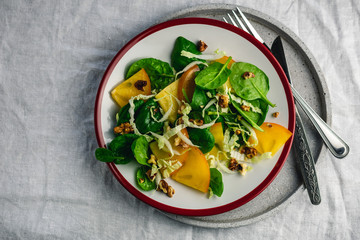 Fresh salad with spinach, Chinese cabbage and persimmon.