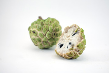 Sugar apple or custard apple with slice isolated on white background, exotic tropical Thai annona or cherimoya fruit