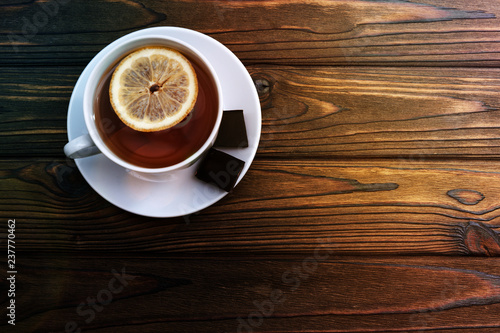 A Cup Of Tea With Lemon Two Pieces Of Chocolate On A Wooden Background Tea Drink Rest Wall Mural Gerasimov174 A Cup Of Tea With Lemon Two Pieces Of Chocolate On A Wooden Background Tea Drink Rest Wall Mural Gerasimov174