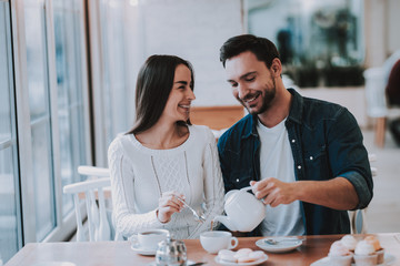 Young Couple is Resting in Cafe