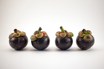 Four mangosteens isolated on white background