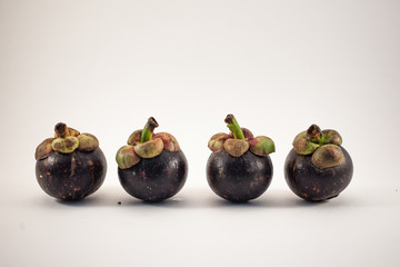 Four mangosteens isolated on white background