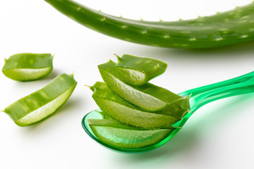 Sliced and whole aloe vera leaf on a white background