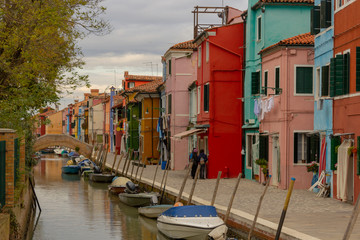 Obraz na płótnie Canvas Burano Island - part of Venice, colored houses on the background of the channel.